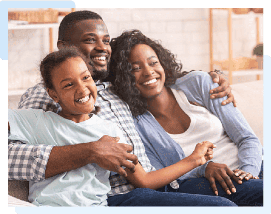 An African Family laughing as they embrace each other.